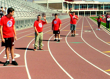 Boys line up to race in a track event.