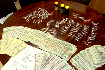 The 1.3 ounces of crack cocaine found mostly in the bottles shown and $3,000 cash seized in the arrests.