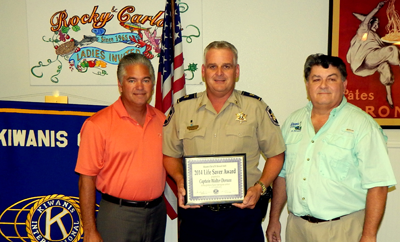 Sheriff James Pohlmann with Life-Saver Award recipient Capt. Walter Dornan and Sam Catalanotto, chairman of the Kiwanis Club Life-Saver Committee.