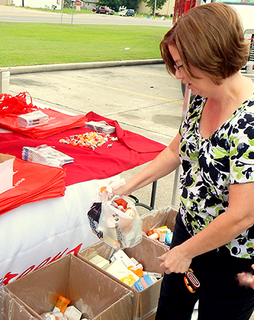 Sharie Waguespack of Chalmette drops medications in a box at the take-back event.