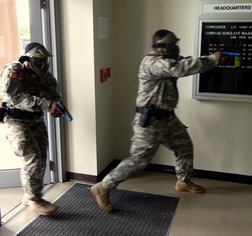 National Guardsmen enter a building at the Jackson Barracks base as part of a simulated active shooter situation on Aug. 27.