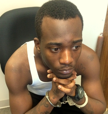 Shiquille Robinson, 21, handcuffed in the sheriff's Criminal Investigations Bureau before being booked with carjacking.