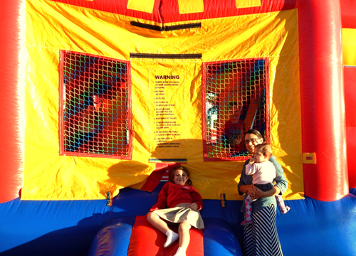 Kassidy Davis, 6, at left, Anna Cazeaux and baby Adalyn Cazeaux, 18 months, outside the bounce center set up for kids at the First Pentecostal Church in Chalmette for the National Night Out Against Crime event on Oct. 14. 