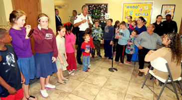 Sheriff James Poh;mann calls up the children and young teen-agers as he talks to church members at the First Pentecostal Church of Chalmette.