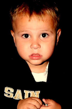 Heath Ragas Jr., 3, holds a Junior Deputy badge he just received at a Night Out event.