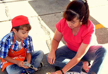 Alex Ricouard, holding a hammer, and Elyce Ricouard of Chalmette, make something together during the Home Depot kids workshop and safety event on Saturday Oct. 4, which drew a large number of parents and children to an event which featured equipment on display from the Sheriff's Office, the Fire Department and Acadian Ambulance.