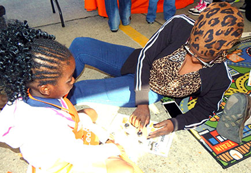 Jighra Funches and Betty Fynches of Violet work on something together in the workshop area.