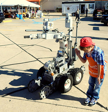 Alex Ricouard of Chalmette has fun with the bomb robot, doing his version of the "The Robot'' dance moves.