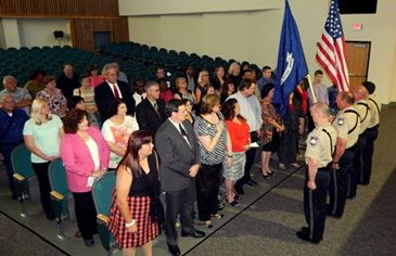 The class stands for the Sheriff's Office Honor Guard, which opened the graduation ceremony.